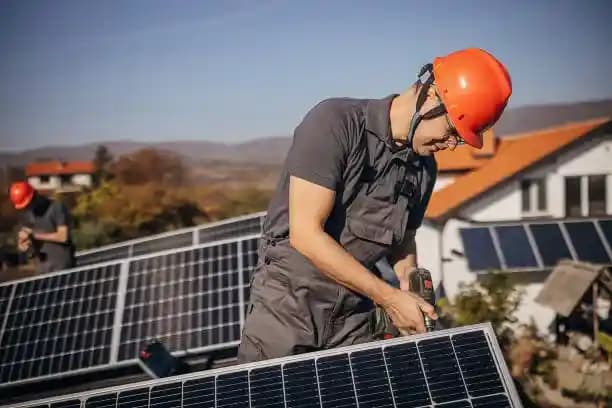Electricias install solar panels.