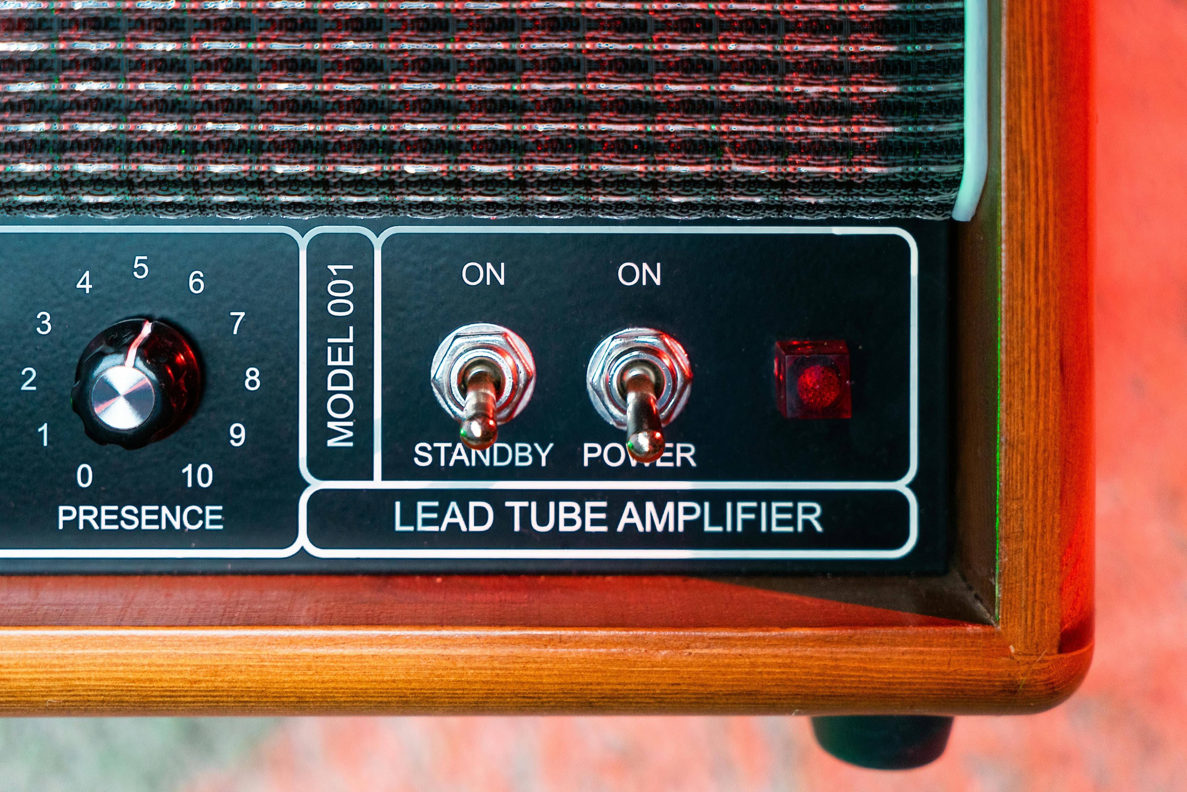 Detailed view of a vintage lead tube amplifier with control switches.