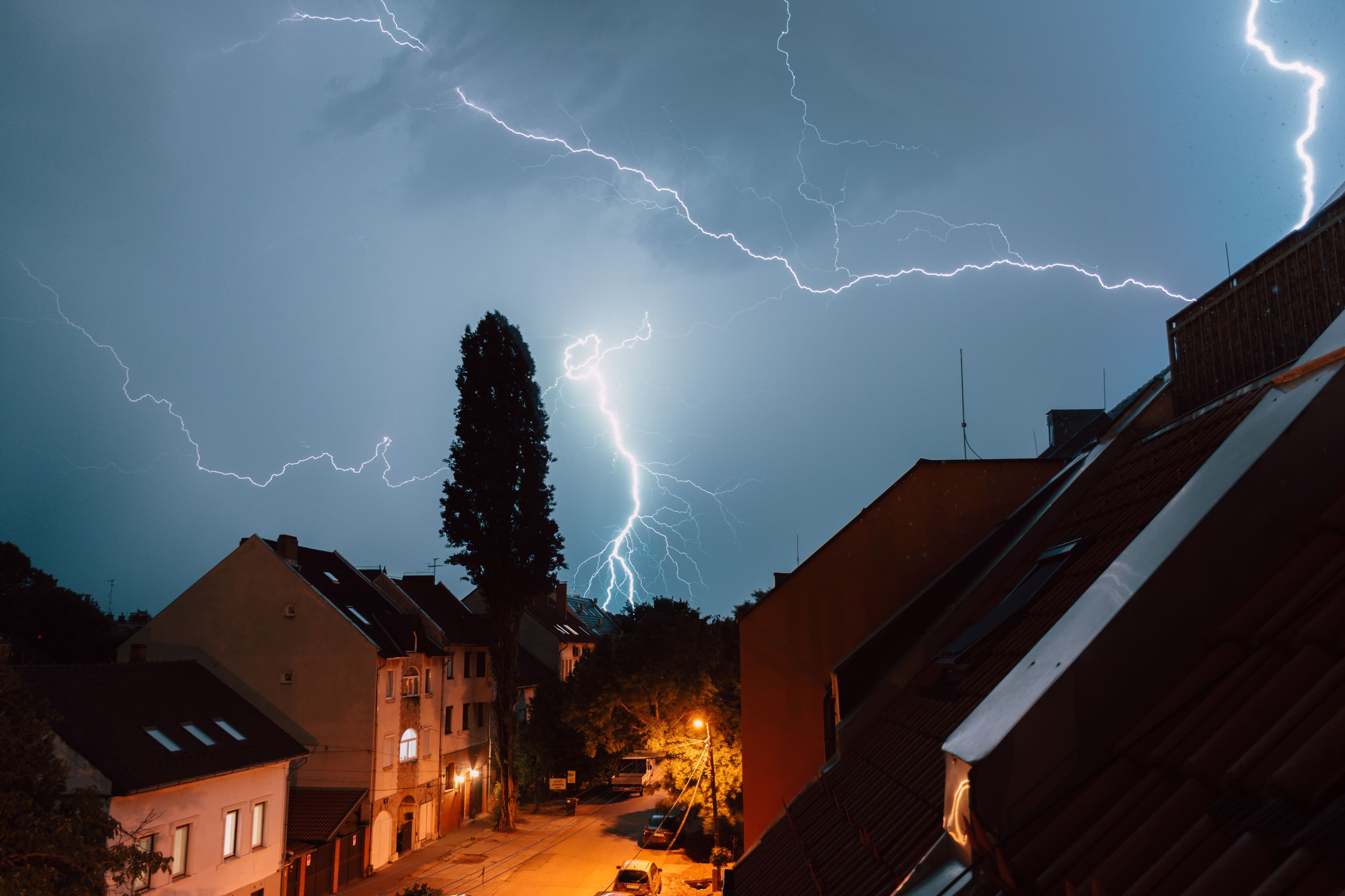 A vivid lightning storm illuminates a residential street in Szeged, Hungary. Captivating night scene.