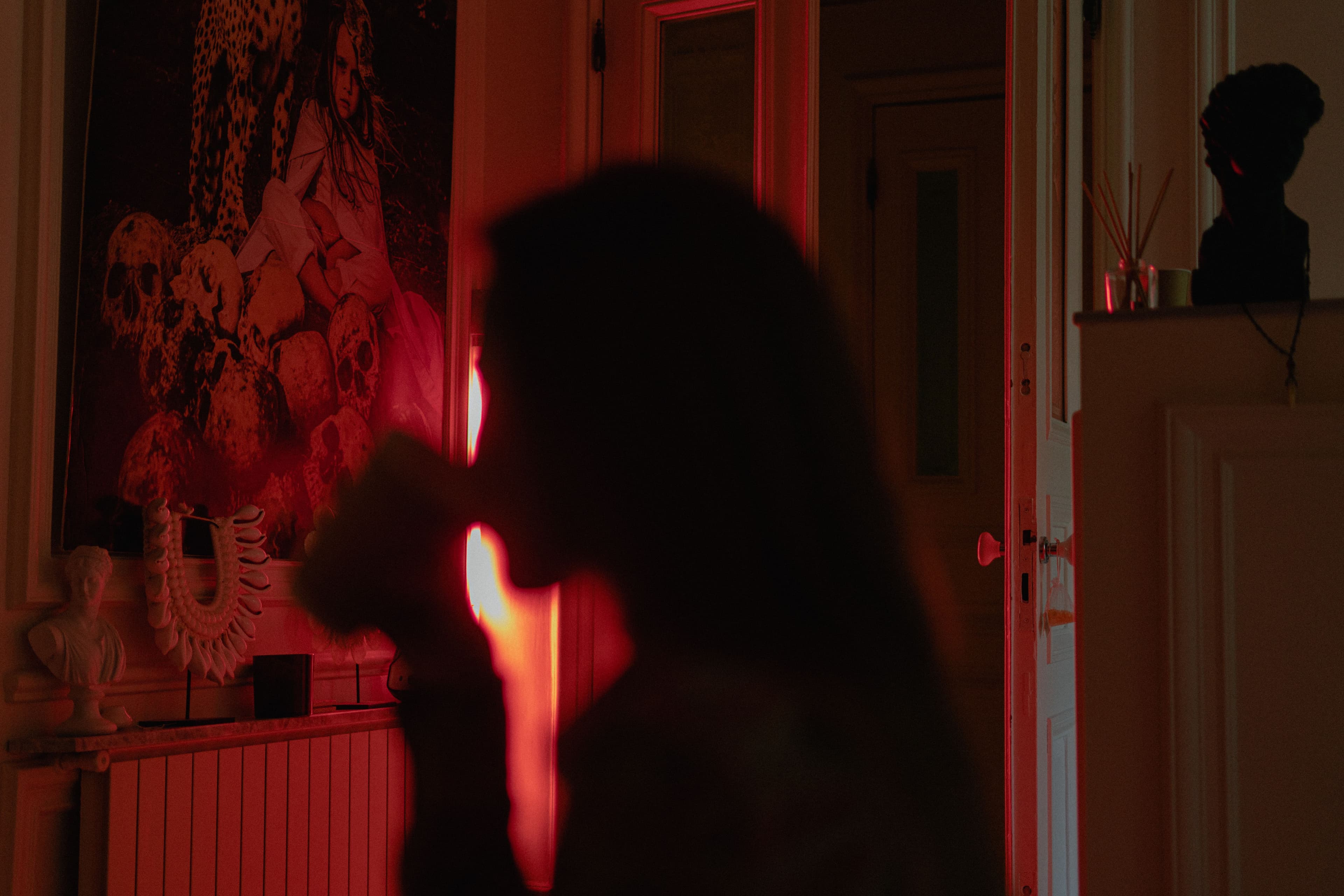 Mysterious silhouette of a woman drinking in a dimly lit room, Istanbul.